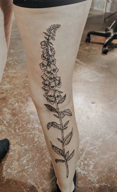 a woman's leg with a flower tattoo on it