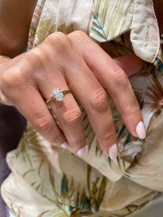 a woman's hand with a ring on it