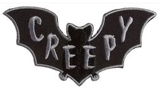 a black and white patch with the word creepy on it's side, in front of an image of a bat