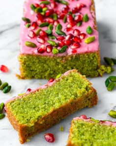 two slices of cake with pink frosting and pomegranates