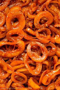 a pile of food that is sitting on top of a table in the middle of some kind of frying