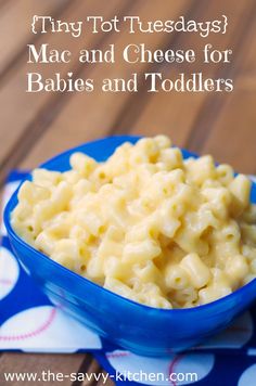 a blue bowl filled with macaroni and cheese on top of a polka dot cloth