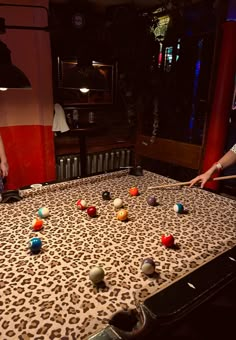 two people are playing with balls on a table