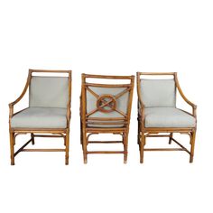 pair of bamboo chairs with upholstered cushions