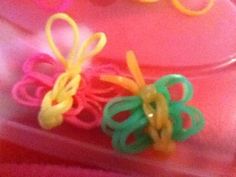 two small plastic hair clips sitting on top of a pink tray next to each other