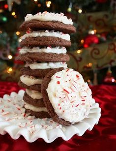 a stack of cookies with white frosting and sprinkles on a plate