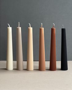 five different colored candles lined up next to each other