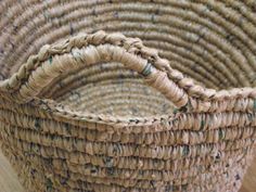 a woven basket sitting on top of a wooden floor