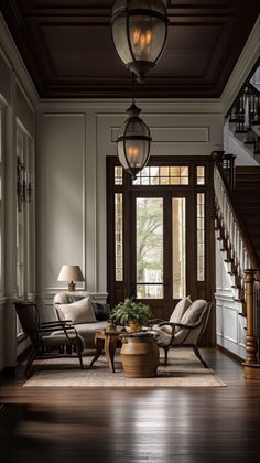 a living room filled with furniture next to a stair case