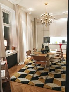 a dining room table with chairs and a chandelier