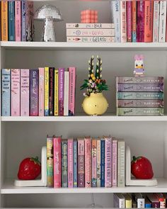 the bookshelf is filled with many different types of books and decorations on it