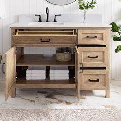 a bathroom vanity with drawers and a mirror above it