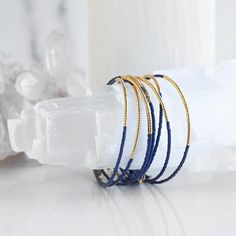 This charmingly delicate Norah Bangle is the perfect accessory for any occasion! It's adjustable and crafted with sparkling glass beads - guaranteed to make you feel like a million glittering bucks. Add a special sparkle to your day with this dainty beauty! Whether you choose just one or choose to stack them on, the Norah Bangle is the perfect addition to your arm party, and is made with love in the USA. memory wire is adjustable to fit most wrists 2mm glass Miyuki beads made in USA includes gift box Layered Bangles, Glass Bead Bracelet, Arm Party, Miyuki Beads, Glass Beaded Bracelets, Memory Wire, How To Make Beads, Bead Bracelet, Glass Bead