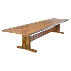 an old wooden table with no one sitting at the top or standing on it's legs