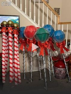 some candy canes are lined up in front of the bannisters on the stairs