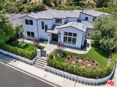 an aerial view of a house with landscaping