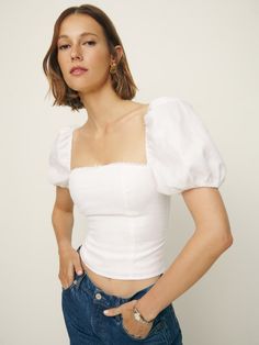 Pretty necessary. Shop the Marella Linen Top from Reformation, a short sleeve top with puffed sleeves, a fitted bodice, and a square neckline. Elegant Short Sleeve Tops With Gathered Sleeves, Fitted Smocked Bodice Crop Top With Short Sleeves, Summer Puff Sleeve Top With Smocked Bodice, Summer Tops With Fitted Bodice And Square Neck, Elegant Fitted Crop Top With Short Sleeves, Fitted Crop Top With Smocked Bodice And Short Sleeve, Fitted Tops With Gathered Sleeves, Summer Smocked Bodice Puff Sleeve Top, Summer Puff Sleeve Fitted Crop Top