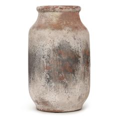 an old vase is sitting on a white surface with red and gray paint all over it