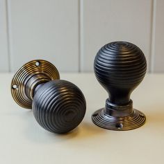 three black knobs on top of a white table