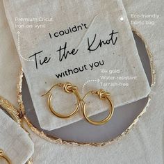 two pairs of gold hoop earrings sitting on top of a white napkin with the words i couldn't tie the knot without you