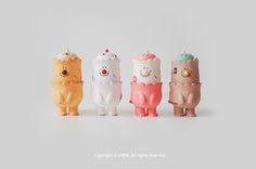 four small toy animals are lined up in the same row and one is wearing an ice cream cone