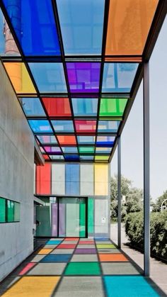 an empty building with multicolored glass on the ceiling