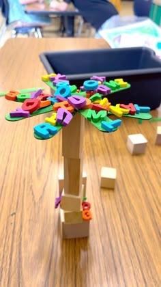 a wooden table topped with lots of colorful magnets and letters on top of it