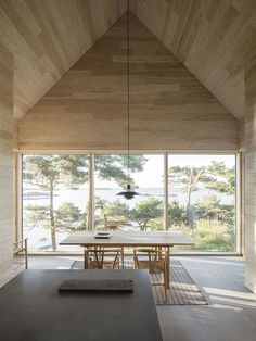 a dining room with wooden walls and flooring