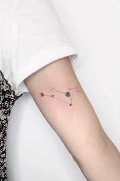 a woman's arm with a small tattoo on the left side of her arm