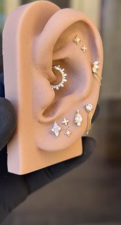 a person holding up a fake ear with stars on it