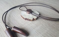 "Handmade bolo tie with engraved BEAR. Unique necklace with statement pendant from deer horn and long leather strip. Original gift for men. 100 % handmade. Great present for hunting, nature, wild animals, Western style lovers. ITEM DETAILS: * Horn thickness is ~ 1/4\" (6-7 mm), * Bolo tie diameter is ~ 2\" (5 cm). * Calibrated leather strap is 1/16\" (2 mm) thick, the ends are decorated with deer horn tips. Horn size, color and shape of this product can be different. ATTENTION FREE OPTIONS ----- Adjustable Brown Bolo Ties For Gifts, Adjustable Brown Bolo Ties As Gift, Brown Bolo Ties As A Gift, Handmade Bolo Ties As Unique Gifts, Brown Bolo Tie For Gift, Brown Necklace With Sliding Knot For Gift, Adjustable Length Brown Jewelry Gift, Brown Adjustable Length Jewelry For Gift, Brown Adjustable Jewelry As Gift