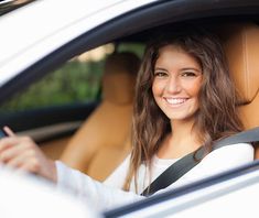 a woman sitting in the driver's seat of a car