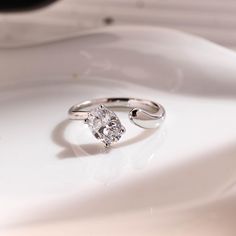 a diamond ring sitting on top of a white plate