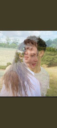 a woman with long hair standing in a field