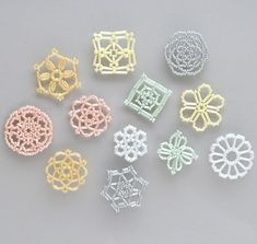 small beaded objects are arranged on a gray surface