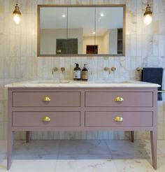 a bathroom vanity with two sinks and a large mirror