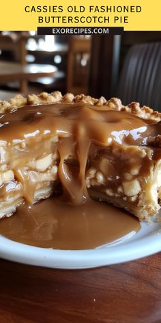 a piece of pie covered in caramel sauce on top of a white plate next to a fork