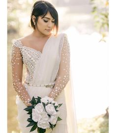 a woman in a wedding dress holding a bouquet