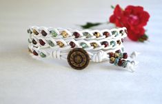 Braided Three Wrap Bracelet, Multicolor Picasso Beads on White Leather. The bracelet is made with picasso beads, braided onto white leather. Button on one end and loop on the other end of bracelet provide closure. The bracelet is 21.5'' long.  Please, let me know if you need another length. The bracelet is lightweight and easy to wear. It will compliment owner's look and outfit. Compliments guaranteed. This Handcrafted piece is a priceless addition to handmade jewelry collection. Awesome gift for someone very special as well If you have any questions please contact me. Other unique wrap bracelets https://www.etsy.com/shop/JewelryByYevga?ref=hdr_shop_menu&section_id=15478050 All JewelryByYevga shop https://www.etsy.com/shop/JewelryByYevga?ref=hdr_shop_menu Handmade Adjustable White Leather Bracelet, Handmade White Leather Adjustable Bracelet, White Handmade Adjustable Leather Bracelet, Adjustable Handmade White Leather Bracelet, White Wrap Bracelet With Colorful Beads For Gift, White Wrap Bracelet With Colorful Beads As Gift, White Hippie Bracelet Jewelry, White Bohemian Beaded Bracelets For Festival, White Bohemian Beaded Bracelets For Jewelry Making