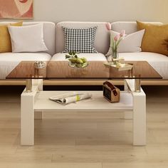 a living room with couches, coffee table and vases on the side tables