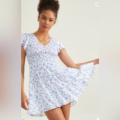 Get Ready To Turn Heads With The Zelda Smocked Floral Dress - A Beautiful And Feminine Mini Dress That's Perfect For Any Occasion! Featuring A Stunning Floral Print, Flutter Sleeves, And A Smocked Bodice For A Comfortable And Flattering Fit, This Dress Is Both Elegant And Playful. The V-Neckline And Tiered Skirt Add A Touch Of Sophistication And Dimension To The Look. To Complete The Look, Pair The Zelda Smocked Floral Dress With Strappy Sandals And A Clutch For A Chic And Effortless Daytime Loo Ditsy Floral Print Smocked Dress For Brunch, White Smocked Mini Dress For Spring, Casual Smocked Dress With Ditsy Floral Print For Brunch, Blue Casual Dresses With Smocked Bodice, Blue Casual Dress With Smocked Bodice, Casual Blue Dresses With Smocked Bodice, Fitted Smocked Dress With Ditsy Floral Print For Spring, White Floral Print Smocked Dress For Brunch, White Flowy Smocked Dress With Short Sleeves