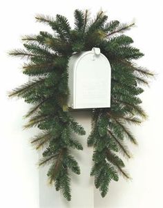 a white mailbox with a wreath on it