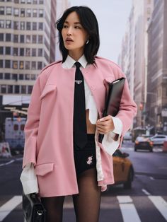 For Love & Lemons Essentials: The Winslow pink cape exudes a sense of timelessness. Crafted in a fuzzy suiting fabric, this collarless jacket is cut to a wide silhouette and features decorative front pocket flaps, on-seam functional pockets, and an epaulette detail at the shoulders. Pink Blazer With Hidden Button Closure For Fall, Tailored Pink Outerwear For Office, Pink Notch Lapel Outerwear For Office, Chic Pink Outerwear For The Office, Chic Pink Outerwear For Office, Chic Pink Outerwear For Work, Trendy Tailored Pink Outerwear, Pink Lapel Collar Outerwear For Office, Chic Pink Outerwear With Pockets