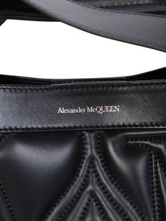 This Alexander McQueen bag boasts a structured silhouette defined by sharp linesQuilted. Embroidered logo on the front. Magnetic fastening. Main compartment. Adjustable detachable shoulder strap. Flat top handles. Color: blackWidth: 43 cm Height: 30 cm Depth: 14 cm Strap: 50 cmMaterial: 100% Calf LeatherMade in ItalyGender: WOMENMaterial: 100% CALF LEATHERColor: BLACKMade in: ITProduct ID: 709566 1BLFU 1000*Import tax/duty will be calculated at checkout (If applicable) Formal Tote Shoulder Bag With Logo Hardware, Black Shoulder Bag With Logo And Double Handle, Luxury Tote Satchel With Logo Hardware, Black Leather Shoulder Bag With Logo, Black Top Handle Shoulder Bag With Logo, Black Satchel With Logo Hardware And Double Handle, Black Double Handle Satchel With Logo Hardware, Formal Double Handle Shoulder Bag With Logo, Leather Business Shoulder Bag With Logo