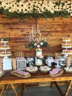 a table topped with lots of cakes and desserts