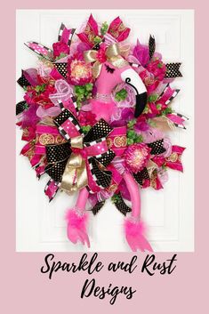 a pink and black flamingo wreath on a door with the words sparkle and rust designs