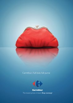 a red purse sitting on top of a blue surface