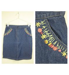 "DESCRIPTION Denim Mini Skirt with pockets and floral embroidery  MEASUREMENTS/SIZE Measurements are taken along one side of garment lying flat  (double for all the way round measurements). Waist: 39cm / 15.6\" Hips: 49cm / 19.3\" Length: 56cm / 22\" Tag shows size S. Please check measurements to make sure it fits you.  MATERIAL 100% Cotton  BRAND Sista  CONDITION  Excellent pre-owned condition   COLOURS Please keep in mind that the actual colour of an item may be slightly different to that show Vintage Embroidered Skirt For Spring, Vintage Embroidered Spring Skirt, Spring Vintage Embroidered Skirt, Embroidered Fitted Denim Skirt, Fitted Embroidered Denim Skirt, Casual Embroidered Fitted Denim Skirt, Embroidered Fitted Denim Skirt, Casual Style, Embroidered Medium Wash Denim Skirt For Summer, Embroidered Fitted Denim Skirt For Spring