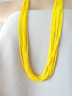 Long Yellow beaded necklace,yellow boho necklace,bridesmaids necklaces,seed bead jewelry,bridesmaids gift,multi strand necklace,summerIt has 12 strands and is available in several lengths. Please read specifications on SIZES below:❤ SIZESThis item comes in several sizes, kindly choose at checkout. The easiest way to find out which length suits you best is to measure a necklace you already own, from one end to the next, including clasp. You can also use the diagram on the pictures as a reference, Yellow Beaded Necklaces With Gold Beads For Beach, Yellow Gold Beaded Necklaces For Beach, Elegant Yellow Beaded Necklaces With Tiny Beads, Yellow Necklaces With Tiny Beads For Jewelry Making, Bohemian Yellow Necklaces With Tiny Beads, Yellow Bohemian Single Strand Beaded Necklace, Bohemian Yellow Single Strand Beaded Necklace, Yellow Faceted Bead Necklaces For The Beach, Yellow Single Strand Bohemian Necklace