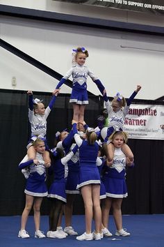 a group of cheerleaders standing on top of each other